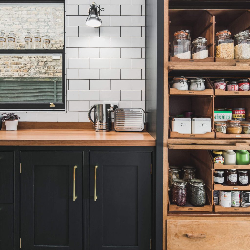 Dark green shaker kitchen with reclaimed vintage haberdashery painted in Obsidian Green