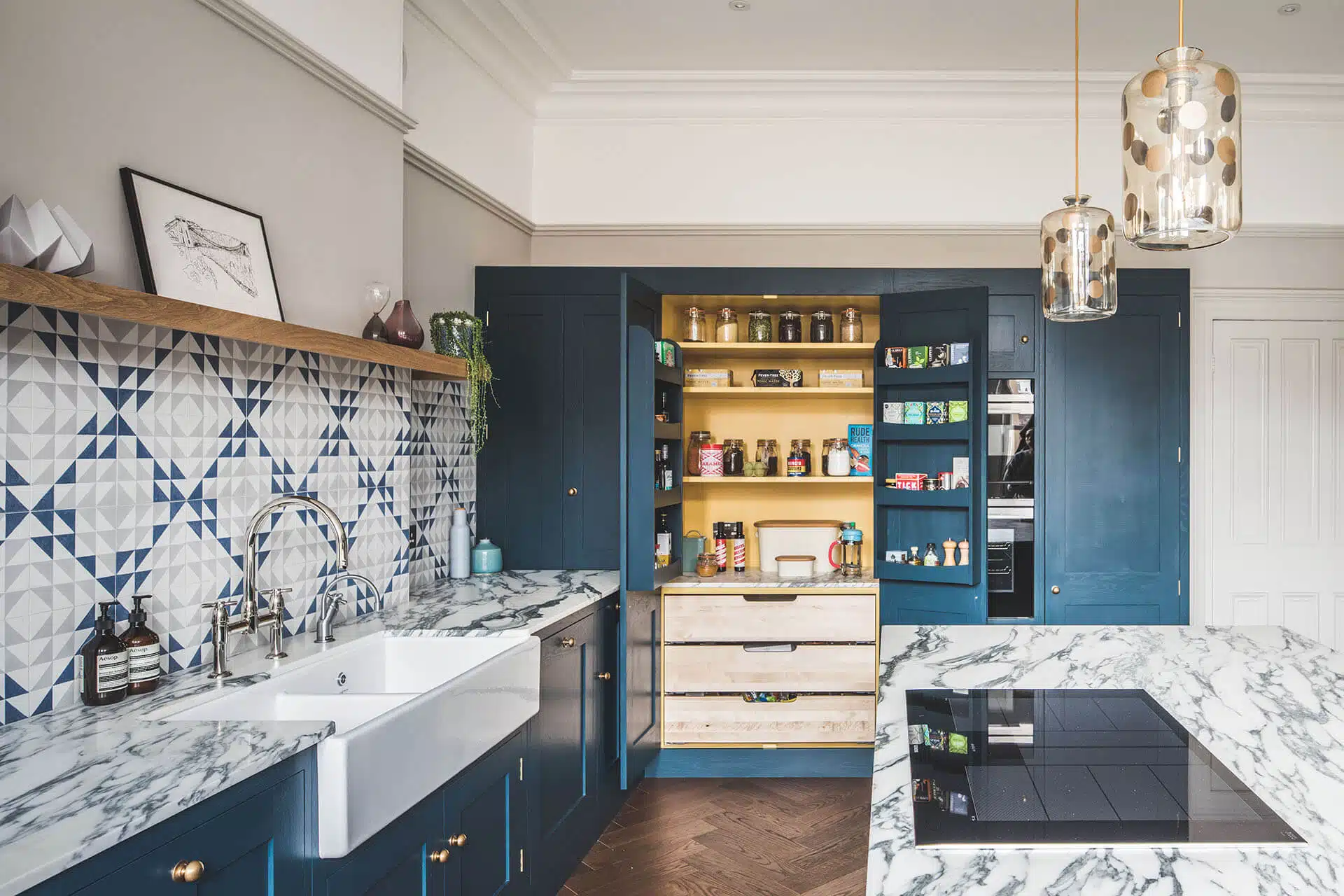 Dark blue geometric kitchen with large pantry cabinet