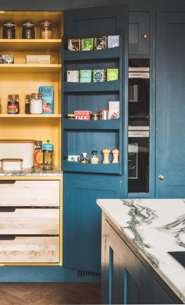 Dark blue geometric kitchen with painted food racks