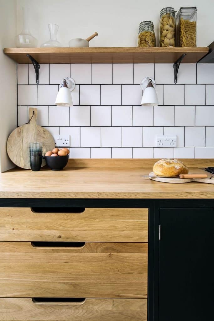 Green industrial galley kitchen with exposed Oak drawers and Oak worktop