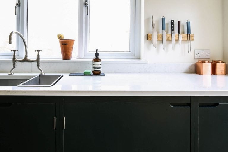 Green industrial galley kitchen with marble worktop and Perrin & Rowe Ionian mixer tap