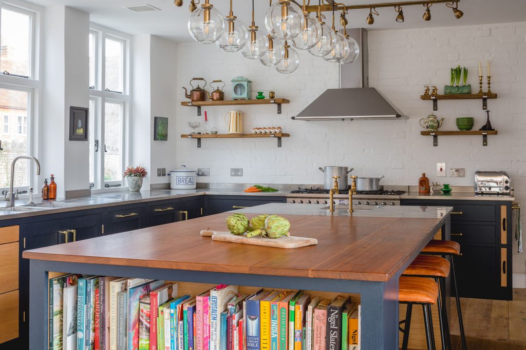 Eco Extension Shaker Kitchen vintage lighting, plants and vegetables on the bespoke island unit made from reclaimed wood and stainless steel