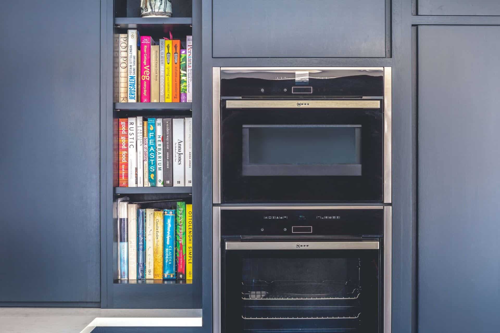 L shape contemporary kitchen with neff oven, liebherr fridge and half larder