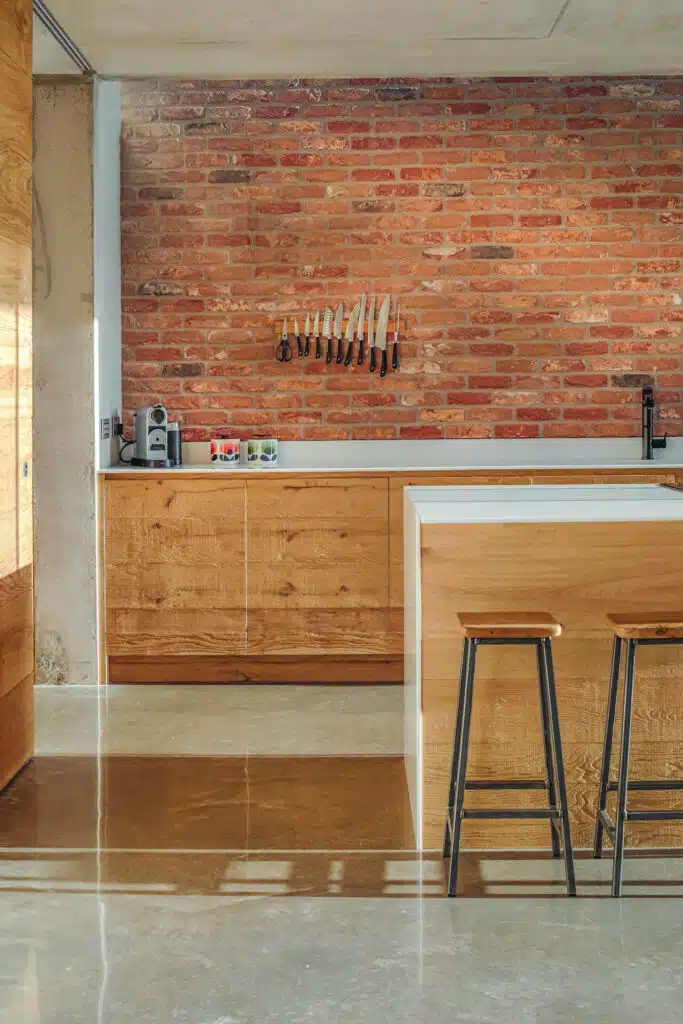 Industrial, reclaimed wood kitchen with concrete and brick
