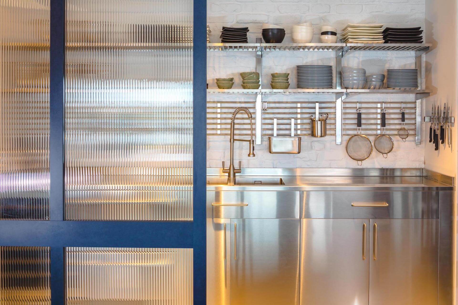 Richilite industrial kitchen with stainless steel and reeded glass screen