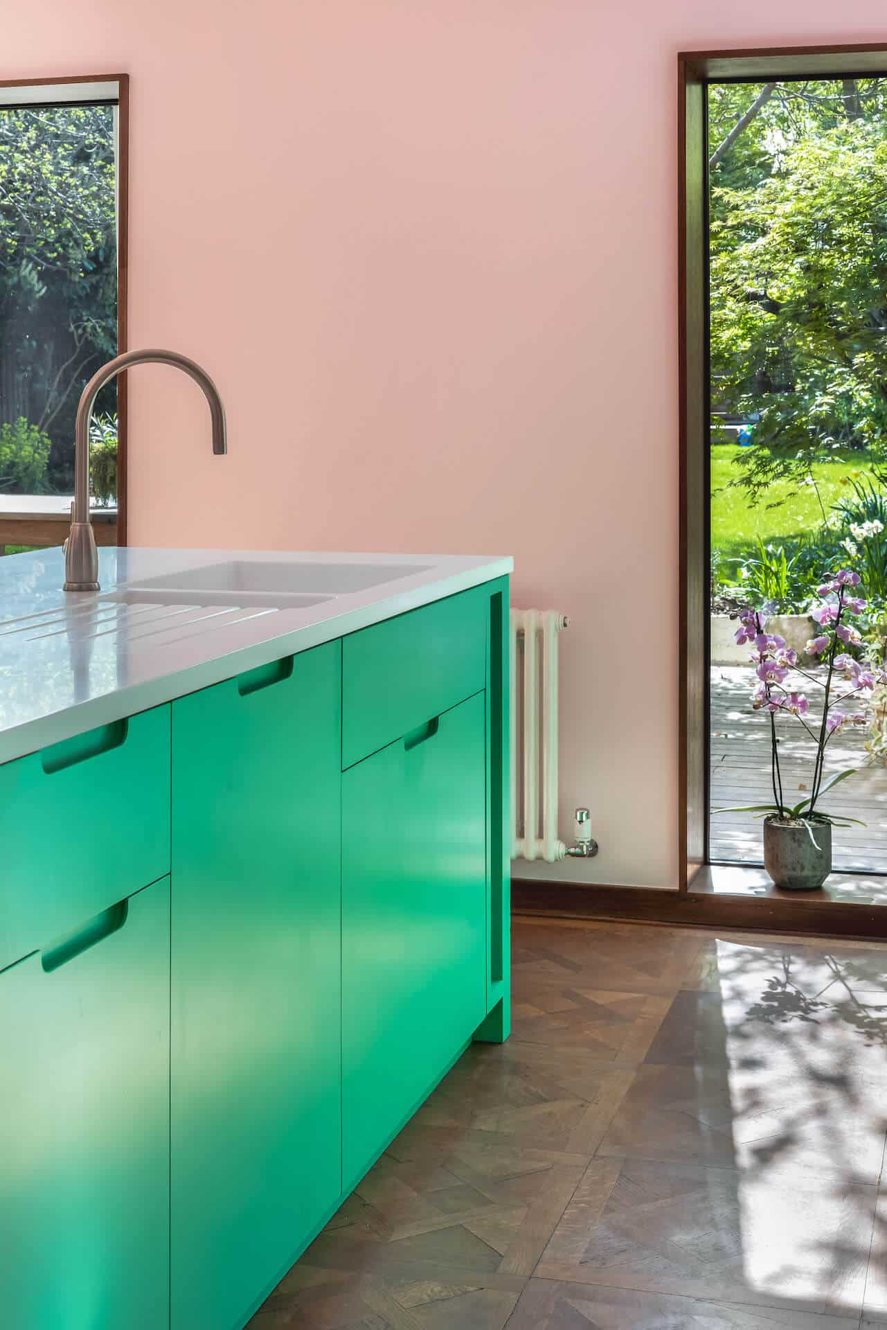 Granada Green Kitchen - Pink and green kitchen with Corian glacier white worktop