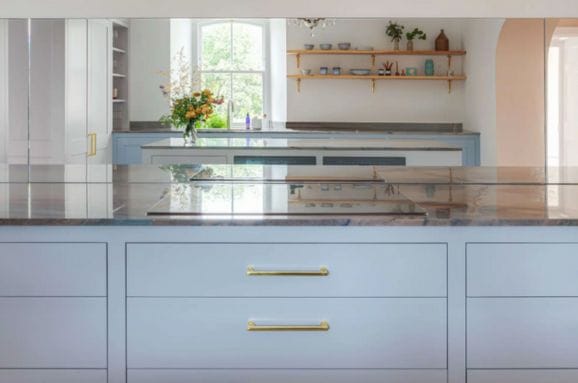 Bespoke kitchen with green in-frame cabinets and oak worktops