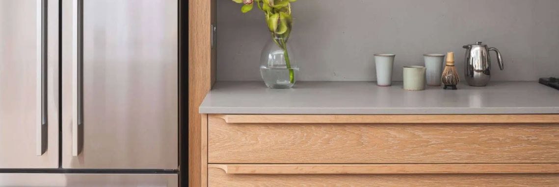 Bespoke kitchen with integrated fridge and full-height cabinetry in a modern layout